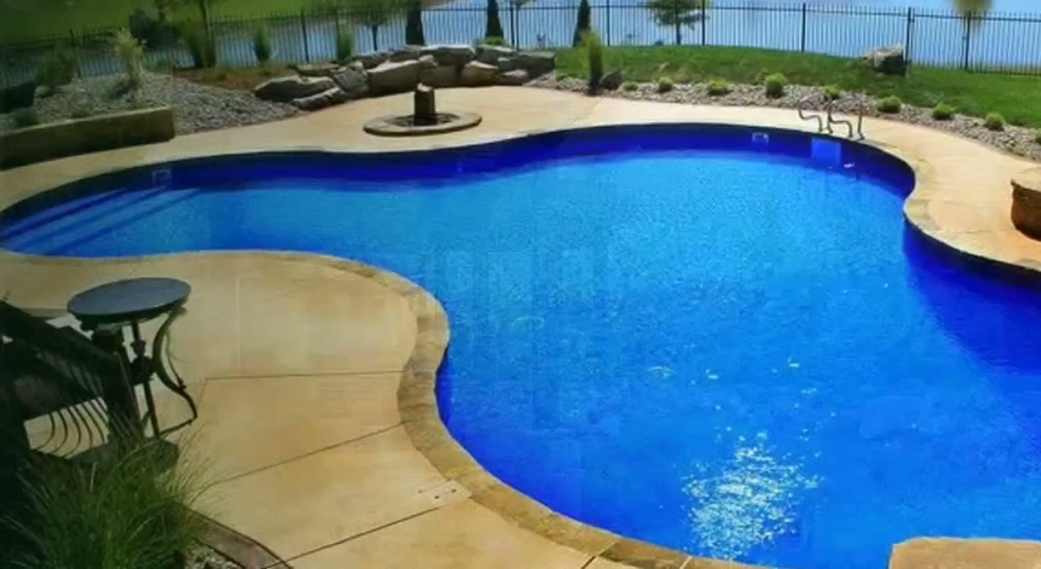 Freeform pool with stone fire bowls — TenderCare project